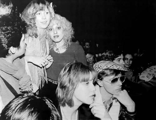 Sable Starr and Nancy Spungen (stood) with Lisa Stein and David Bowie (seated), 1976